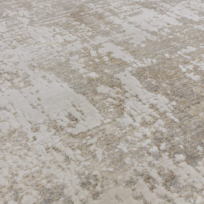 Neutral abstract area rug with textured beige and grey pattern, close-up angle