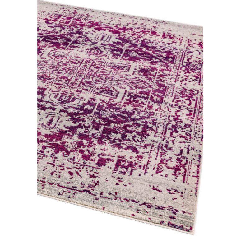 Purple patterned area rug with distressed vintage design on cream background, corner view