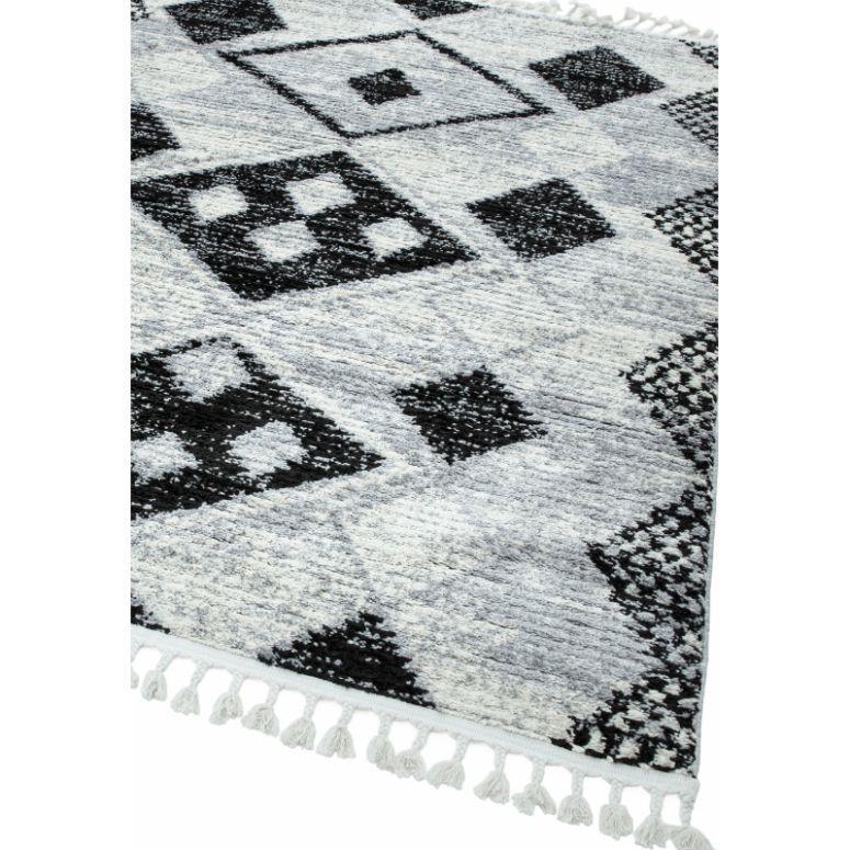 Grey geometric patterned rug with black accents and tassel fringe detail