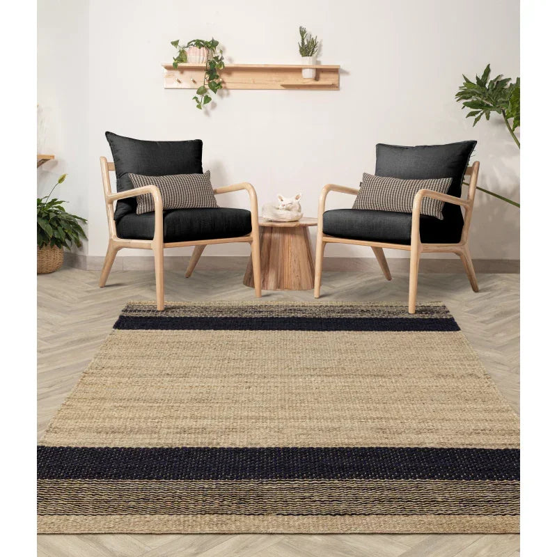Natural jute rug with black stripes in modern living room with wooden armchairs