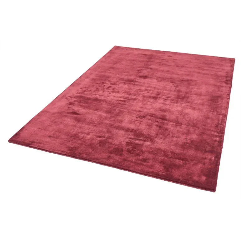 Plush red area rug with soft texture and rectangular shape on white background