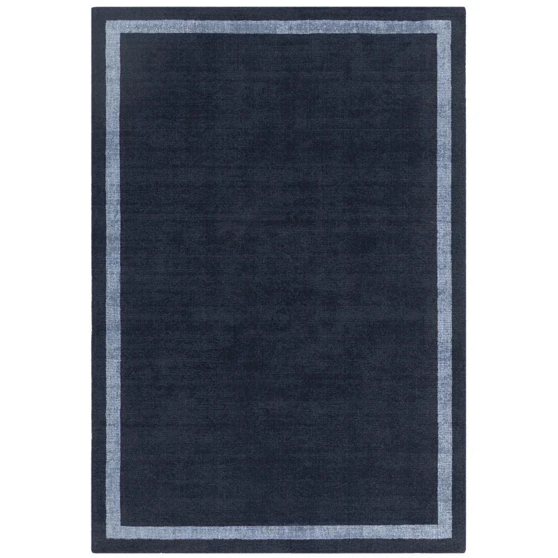 Navy blue area rug with light blue border and simple modern design