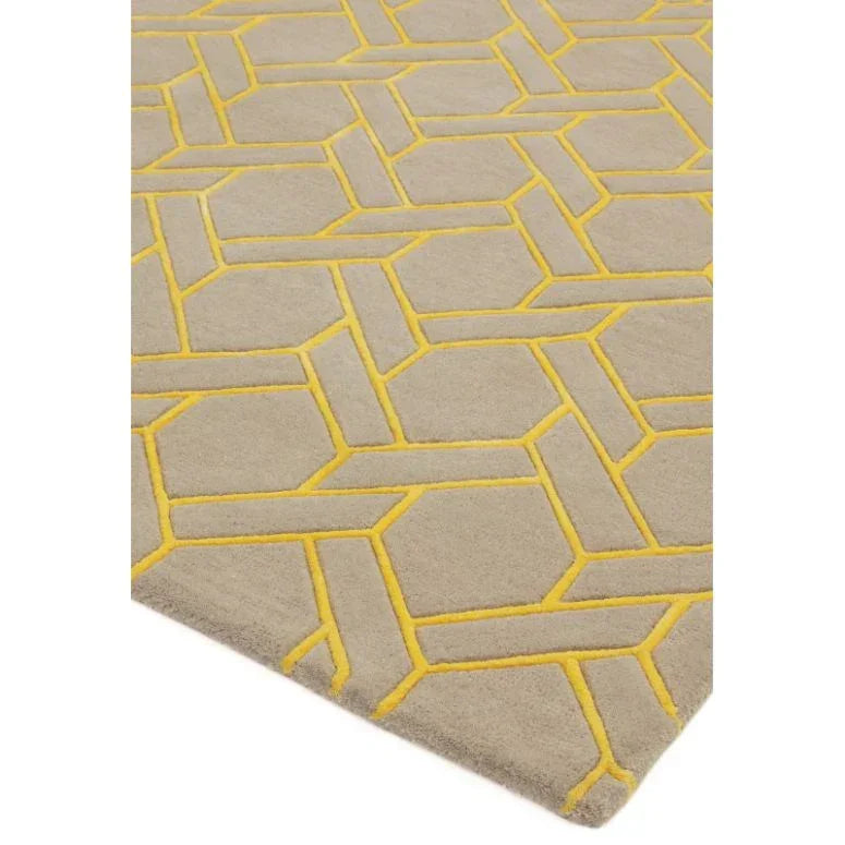 Beige area rug with yellow geometric pattern and textured surface, angled corner view