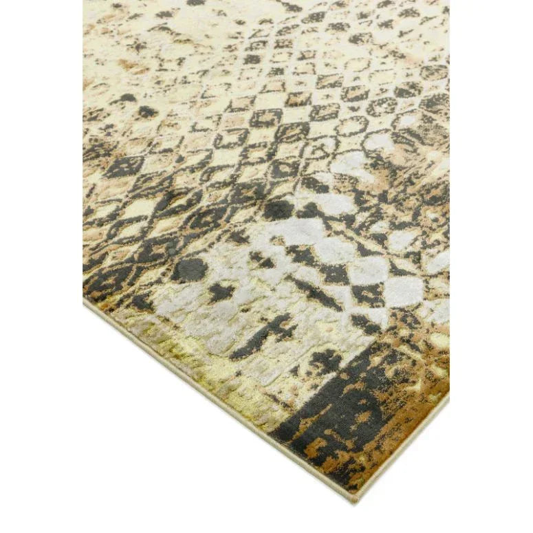 Geometric pattern area rug with distressed beige, brown, and black tones corner view