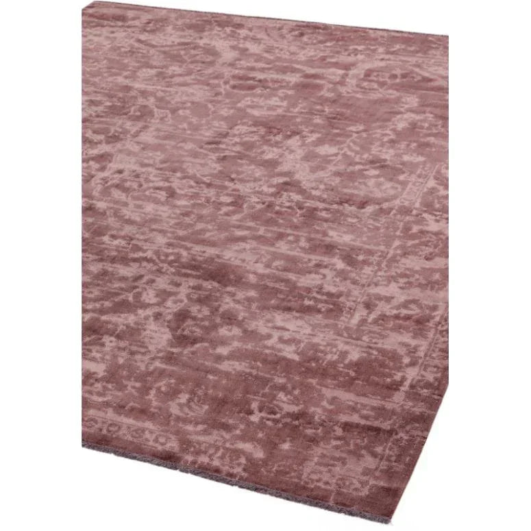 Mauve area rug with distressed pattern and soft pile, shown from an angled view