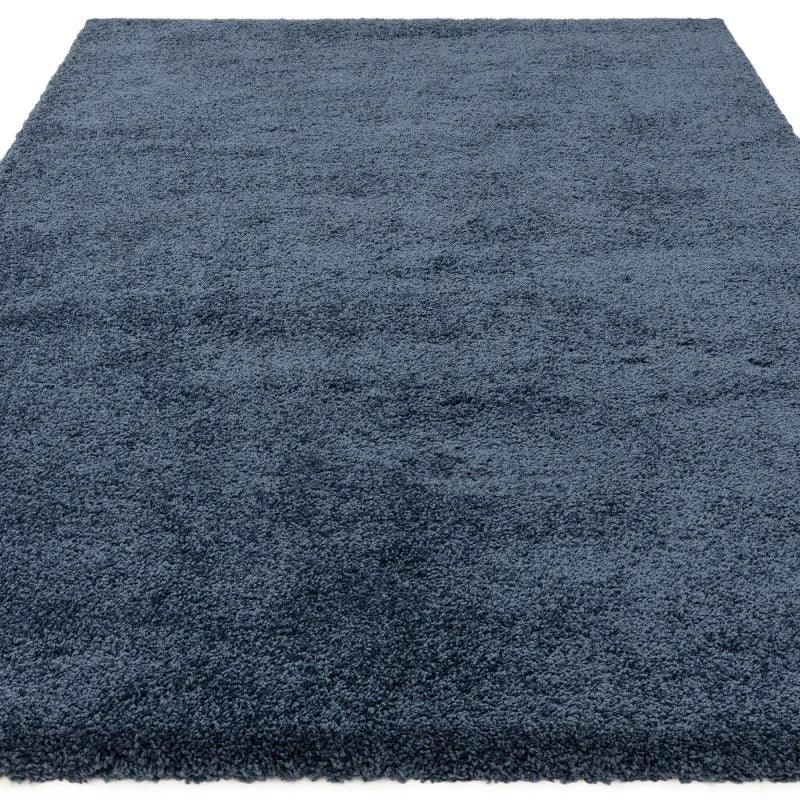 Blue shaggy area rug with thick pile texture, displayed on a flat surface