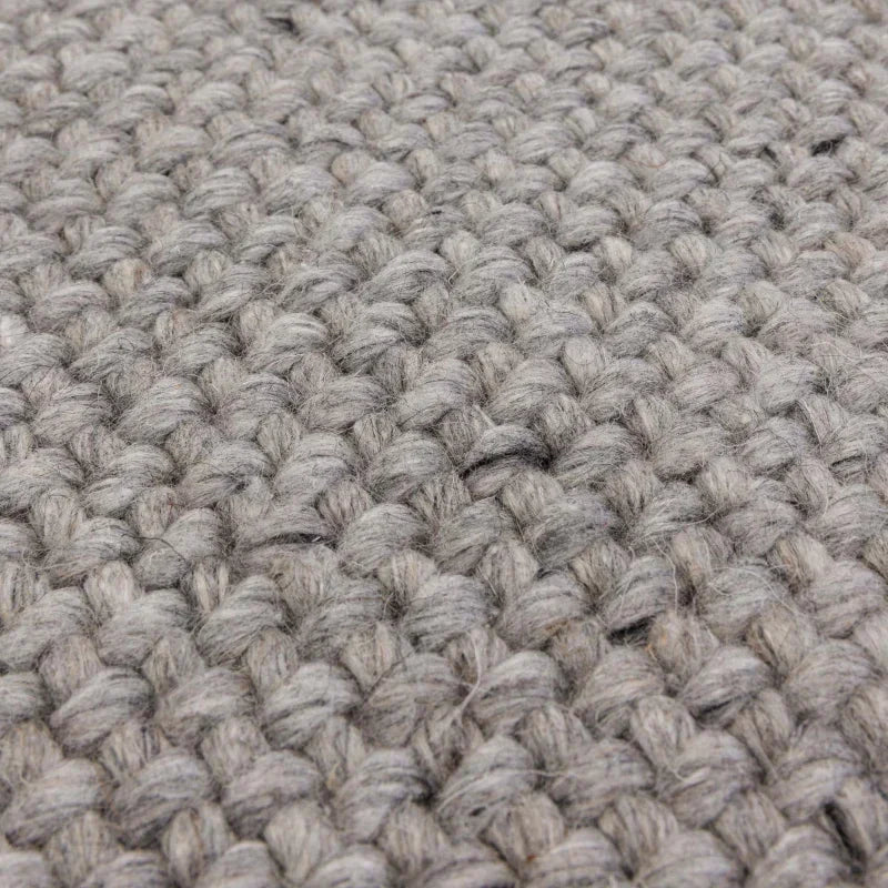 Closeup of grey woven wool rug texture