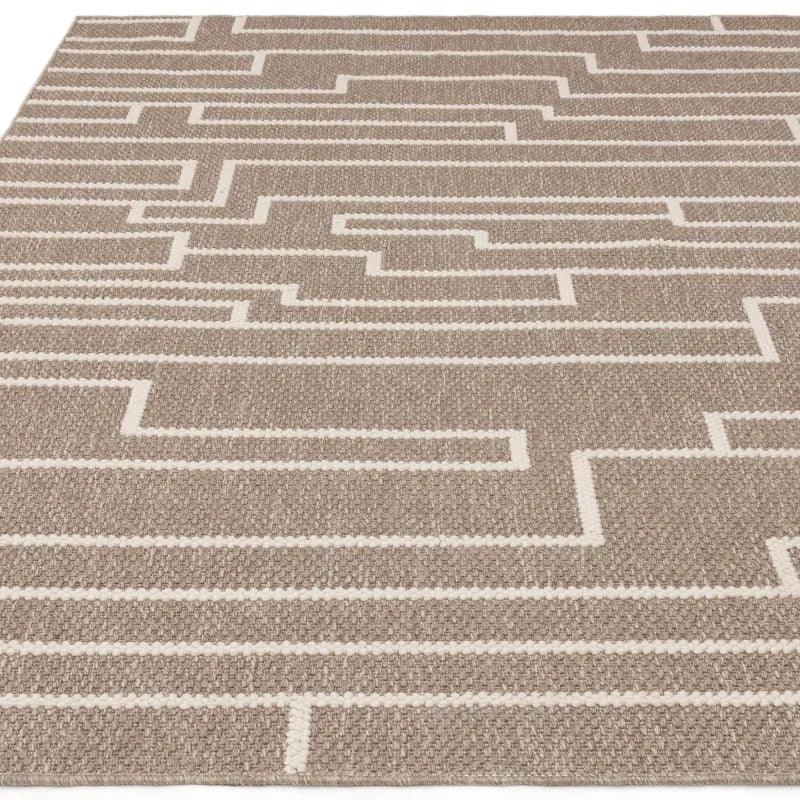 Beige geometric pattern rug with textured surface and white linear accents