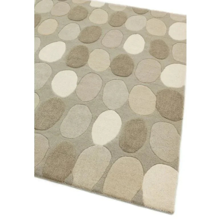 Beige and cream patterned rug with oval stone shapes and soft textured surface