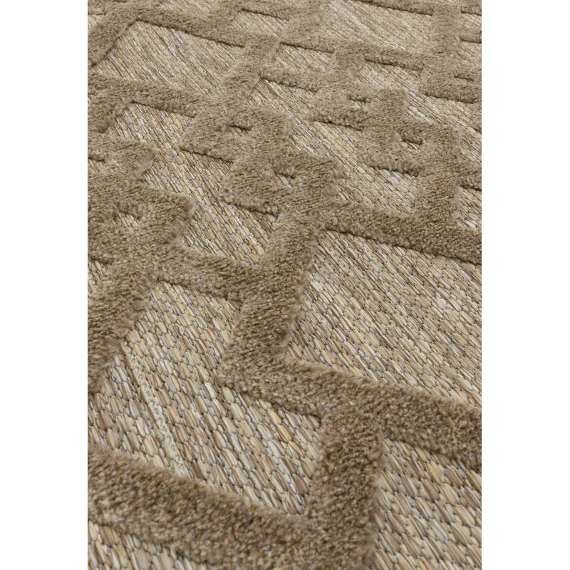 Beige textured rug with raised geometric pattern and woven jute detail, angled closeup view