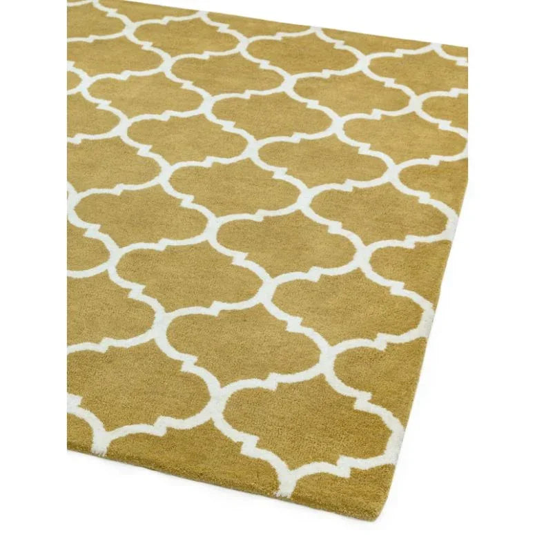 Mustard yellow area rug with white Moroccan trellis pattern, corner angled view