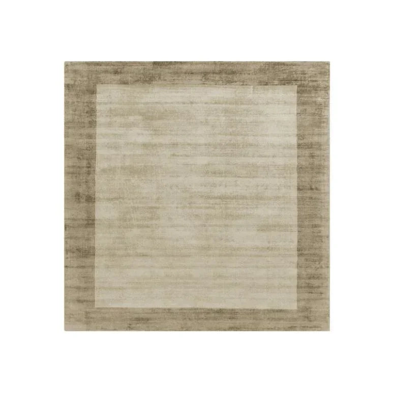 Beige area rug with a wide textured border and subtle two-tone rectangular design