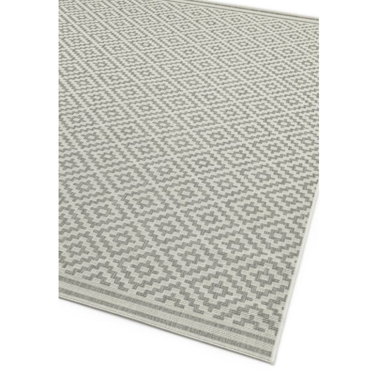 Grey geometric pattern rug with diamond design and textured weave, corner view