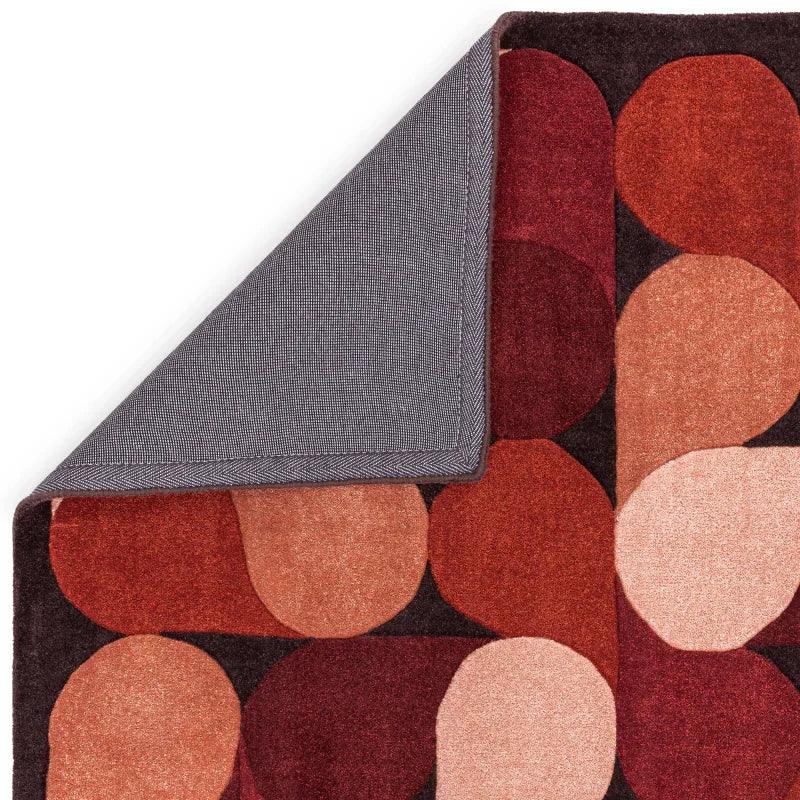 Abstract multicolor geometric area rug with rounded shapes and contrasting dark backing