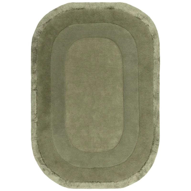 Oval green rug with plush texture and layered border design