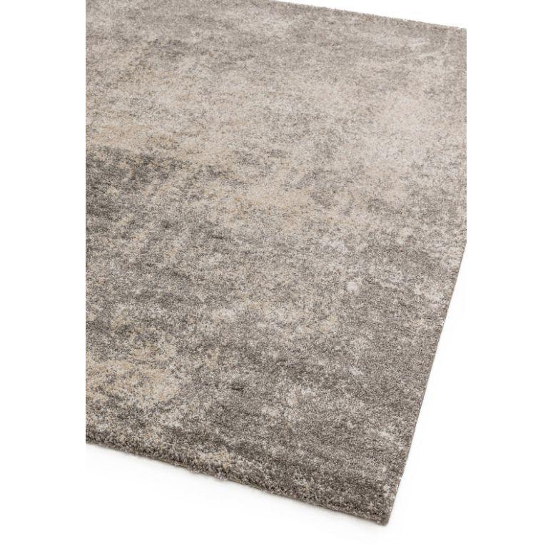 Grey area rug with textured surface and subtle beige pattern, close corner view