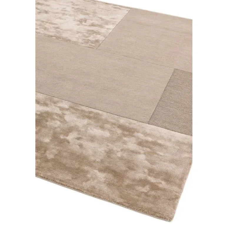 Beige modern rug with textured patchwork design and soft finish