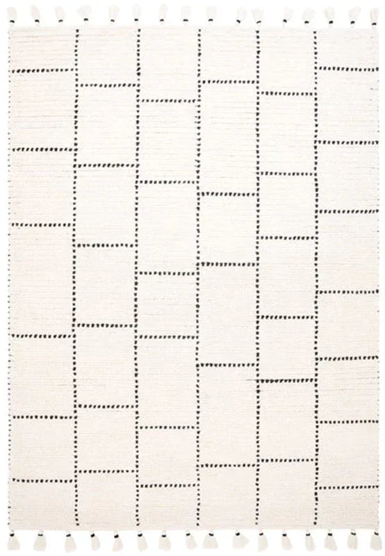 Cream area rug with geometric black dashed lines and tassel fringe