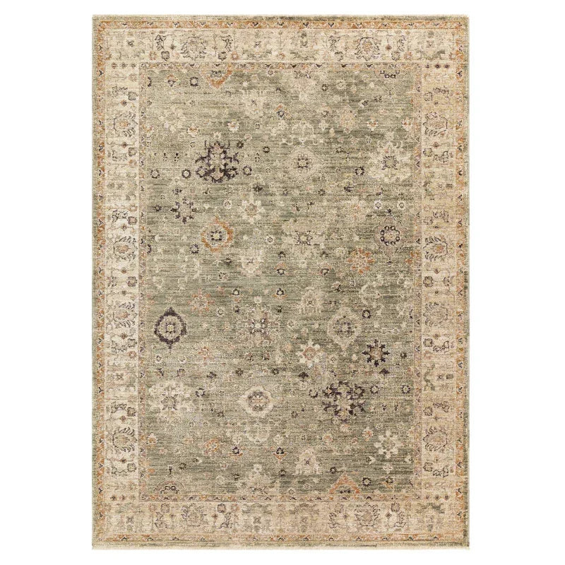 Traditional green patterned area rug with beige border and intricate floral motifs