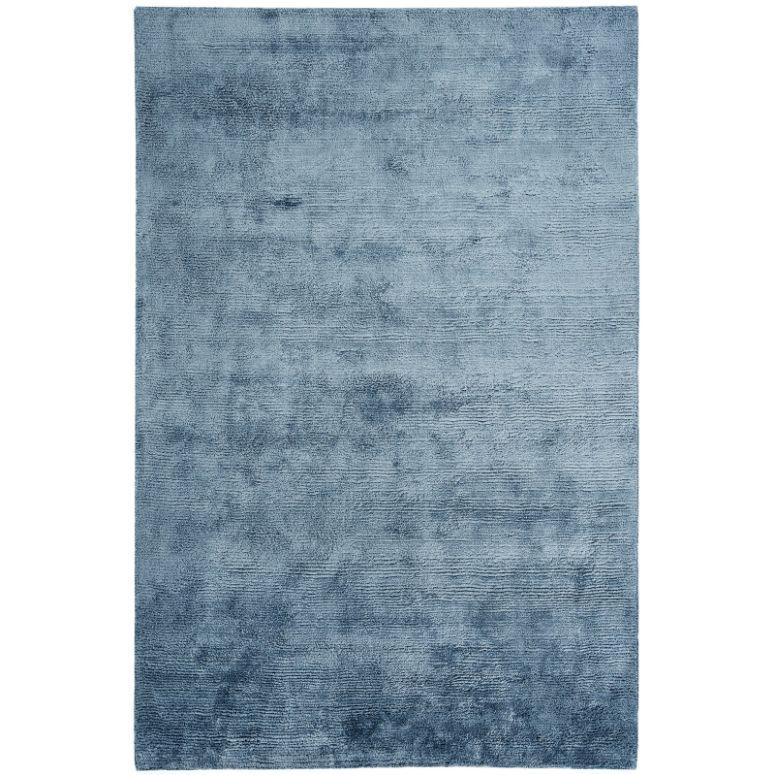 blue area rug with subtle textured pattern and rectangular shape