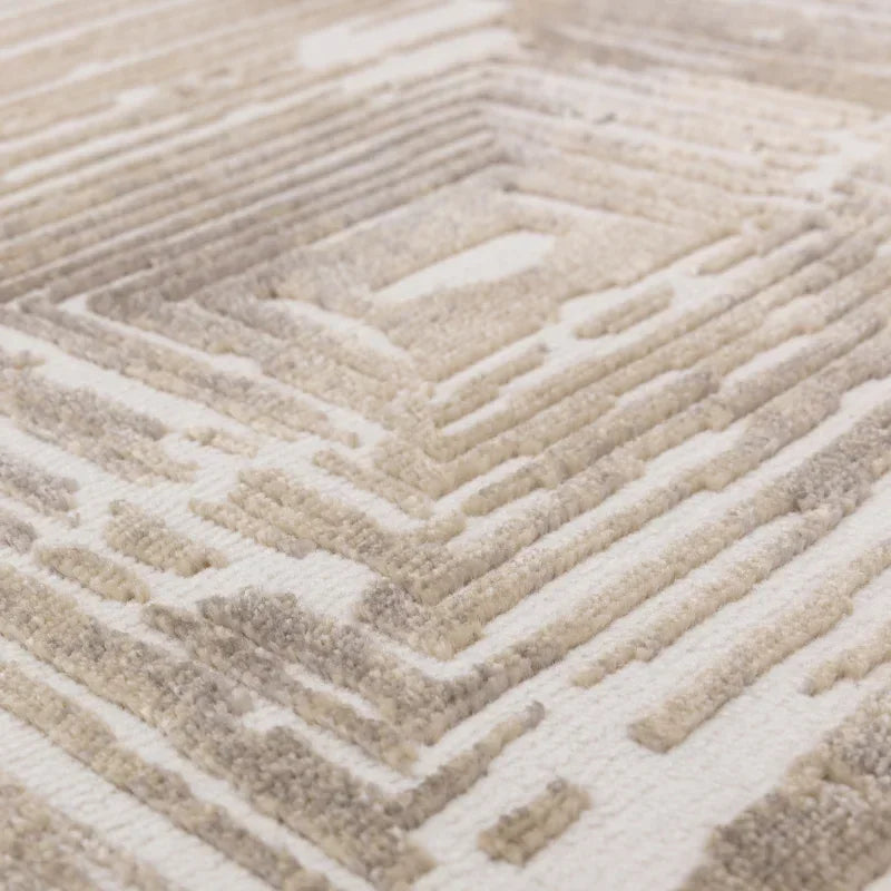 Beige geometric textured rug with raised pattern and soft pile detail close-up