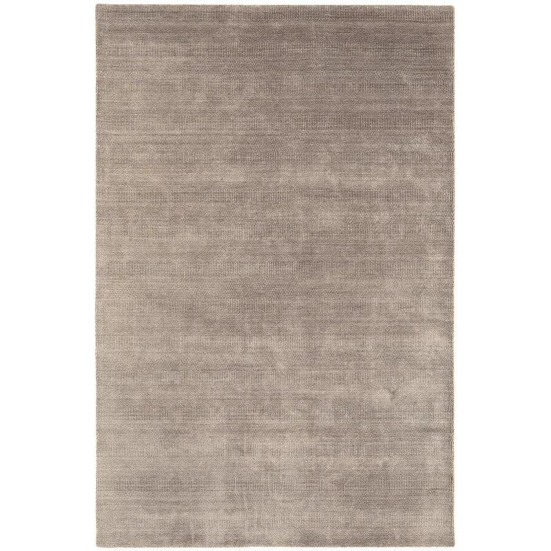 Large rectangular beige area rug with subtle textured pattern and short pile