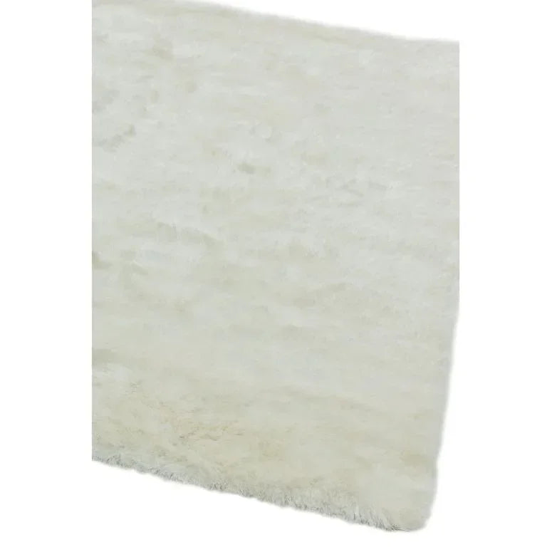 Cream shaggy rug with soft texture, close-up of corner and surface detail
