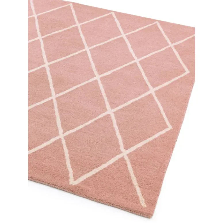 Pink area rug with white crisscross line pattern, shown from a corner angle