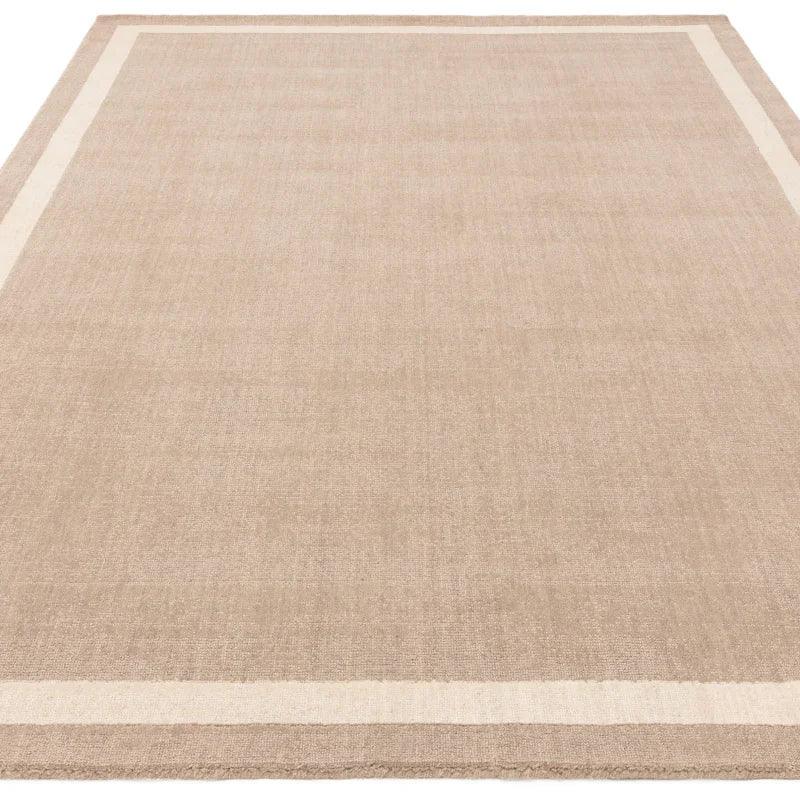 Beige area rug with subtle cream border, rectangular and flatwoven for living room