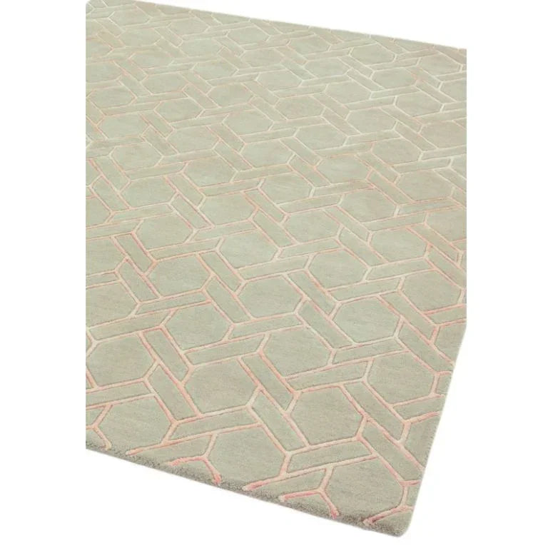 Grey geometric rug with pink accents and raised textured pattern