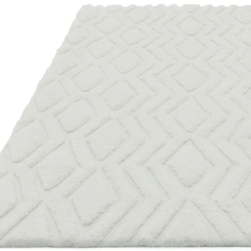 White geometric rug with raised diamond pattern and textured surface