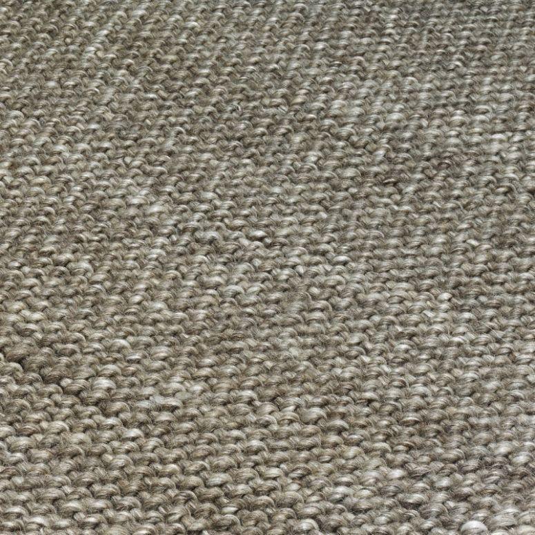Closeup of textured woven rug in natural beige tones