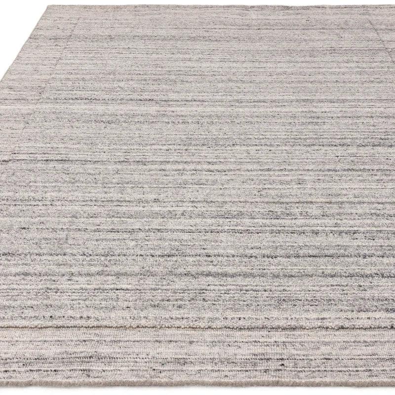 Grey textured area rug with subtle horizontal stripe pattern