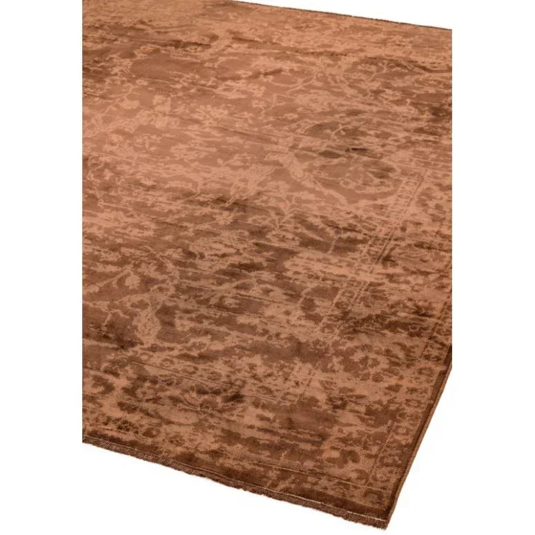 Brown patterned area rug with subtle distressed texture, angled corner view
