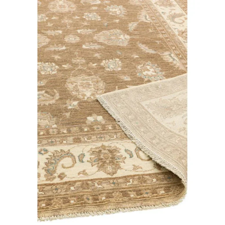 Beige and brown patterned area rug with floral motifs and fringed edge