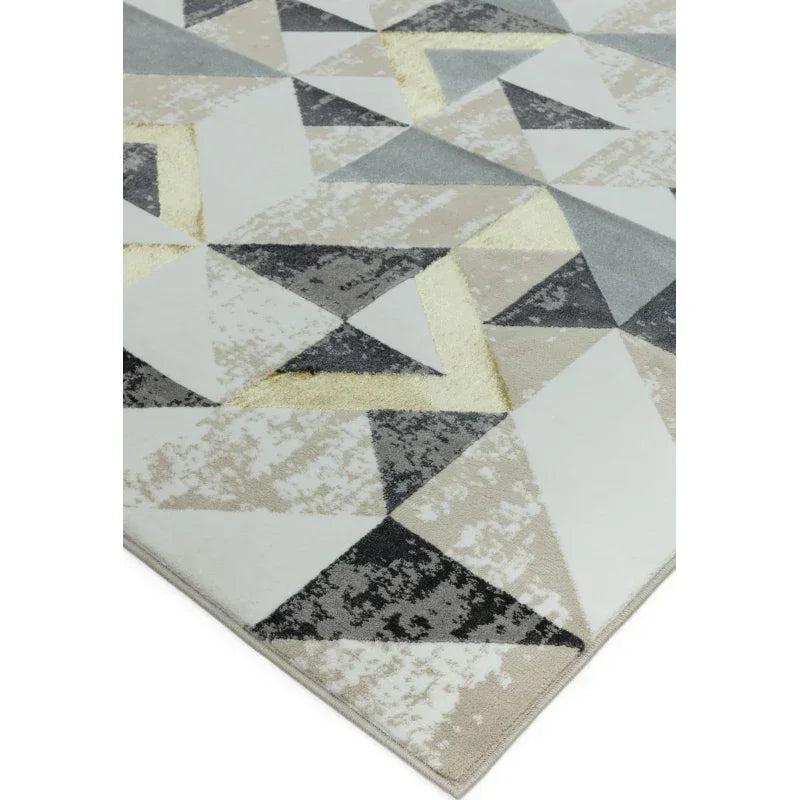 Geometric area rug with grey, beige, and yellow triangles on a cream background