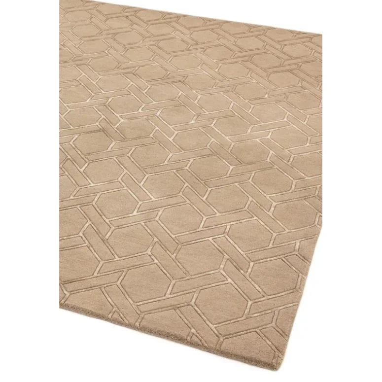 Beige geometric patterned rug with raised texture and soft finish, shown angled view