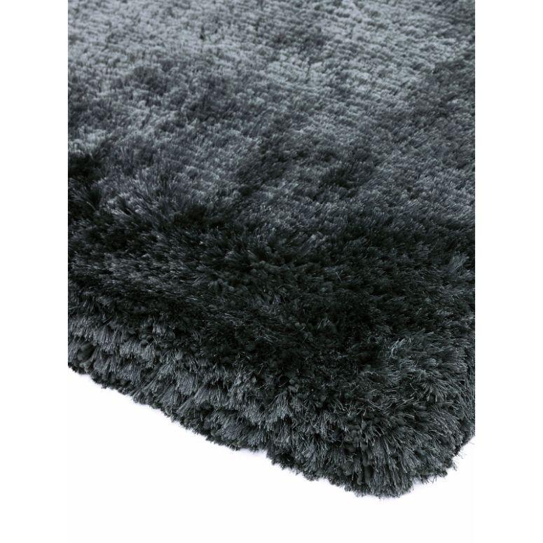 Closeup of soft dark grey shaggy rug corner with plush texture