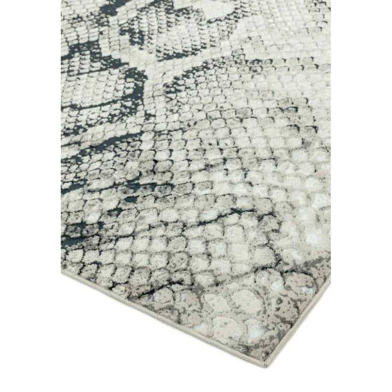 Modern area rug with grey and cream abstract pattern and textured surface close-up