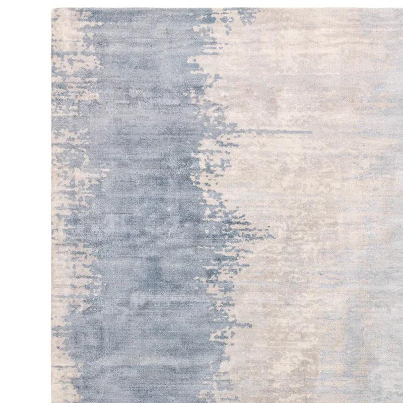 grey and cream abstract area rug with textured pattern shown from top angle