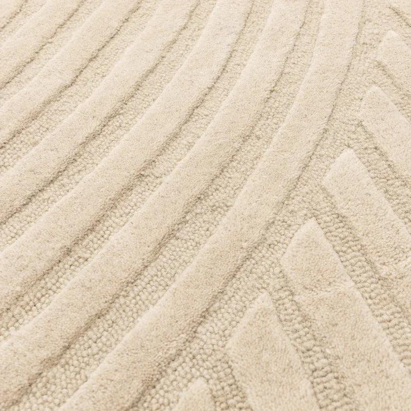 Cream textured rug with raised geometric pattern and soft pile close-up