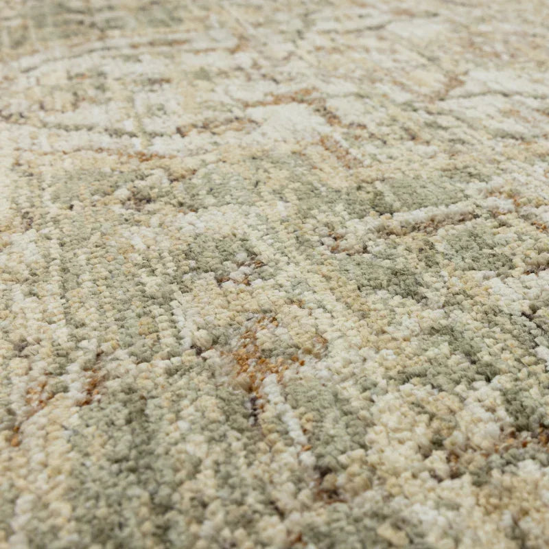 Closeup of textured beige and green rug surface with subtle geometric pattern