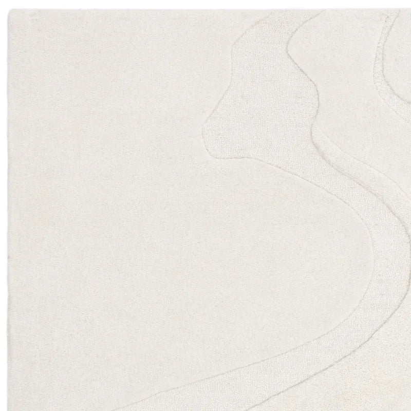 Cream textured area rug with subtle abstract line pattern, close-up corner view