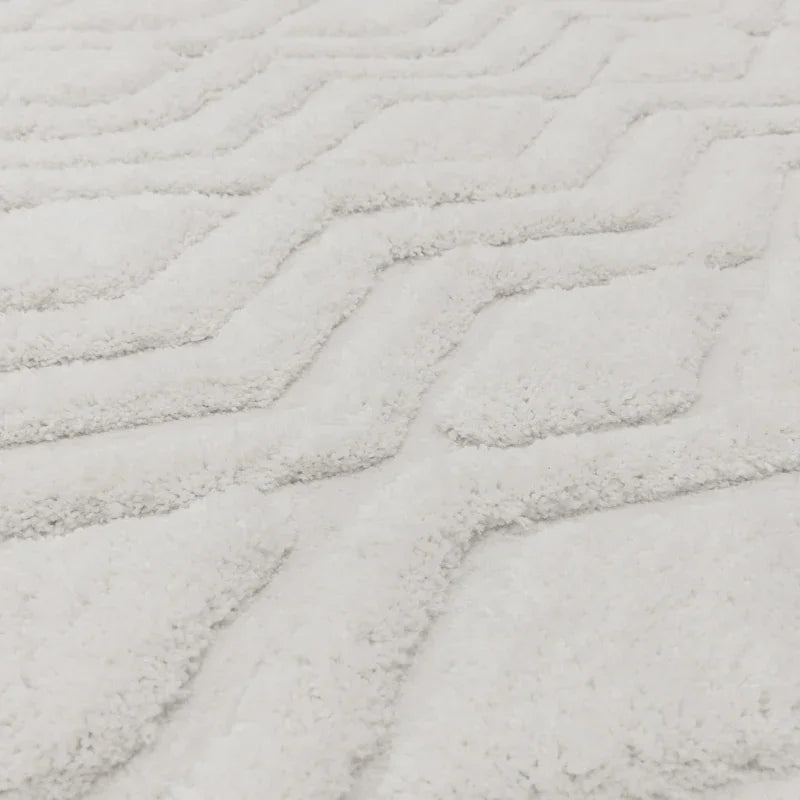 White textured rug with geometric raised pattern, close-up of soft pile detail