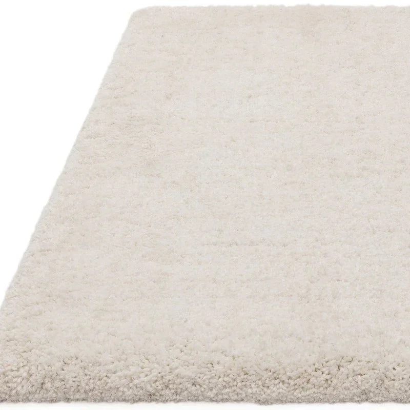 Cream shaggy rug closeup showing soft pile texture and rectangular shape