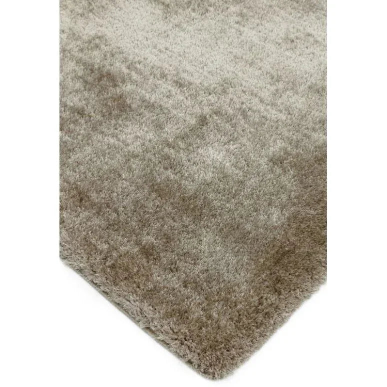 Beige shaggy rug with soft texture and rounded corner close-up view