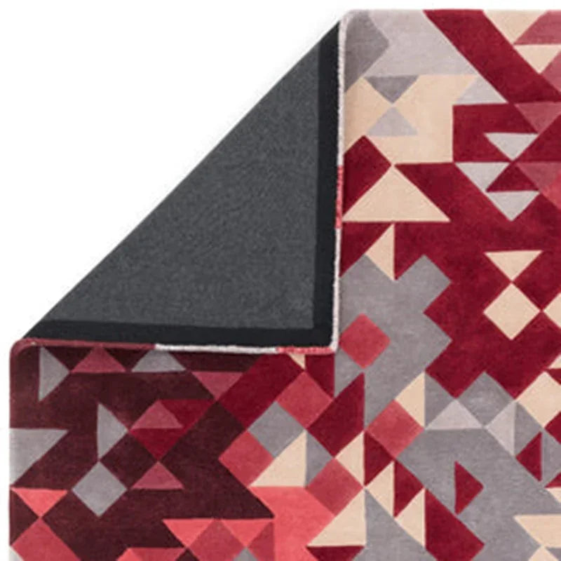 Red geometric patterned rug with non-slip backing, corner folded to show underside