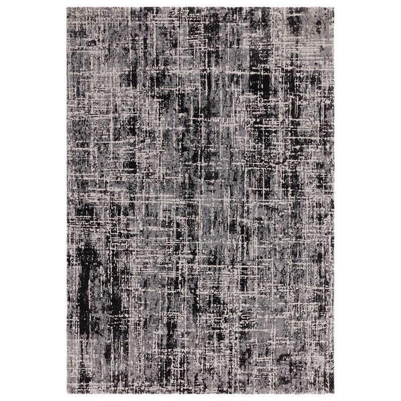 Rectangular area rug with abstract black and grey pattern and textured surface