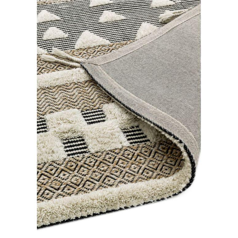 Geometric pattern area rug in beige and cream with corner flipped to show underside texture