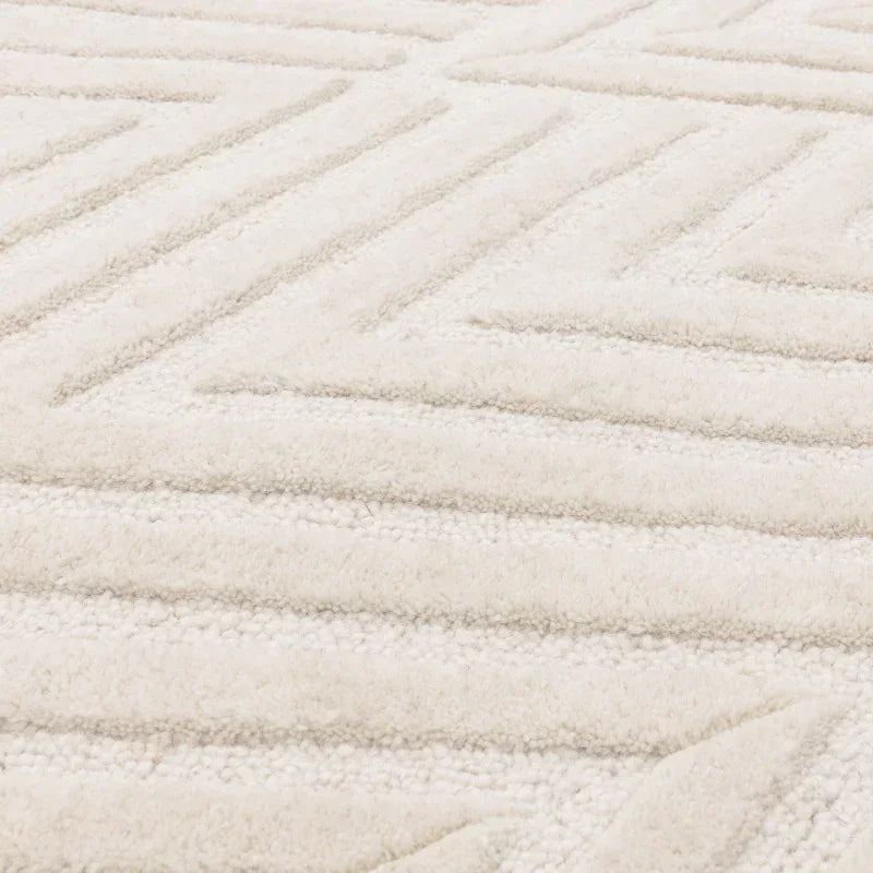 Close-up of cream geometric textured rug with raised pattern detail